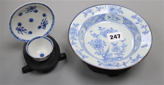 An 18th century Chinese blue and white tea bowl and saucer, and a similar bowl and two hardwood stands